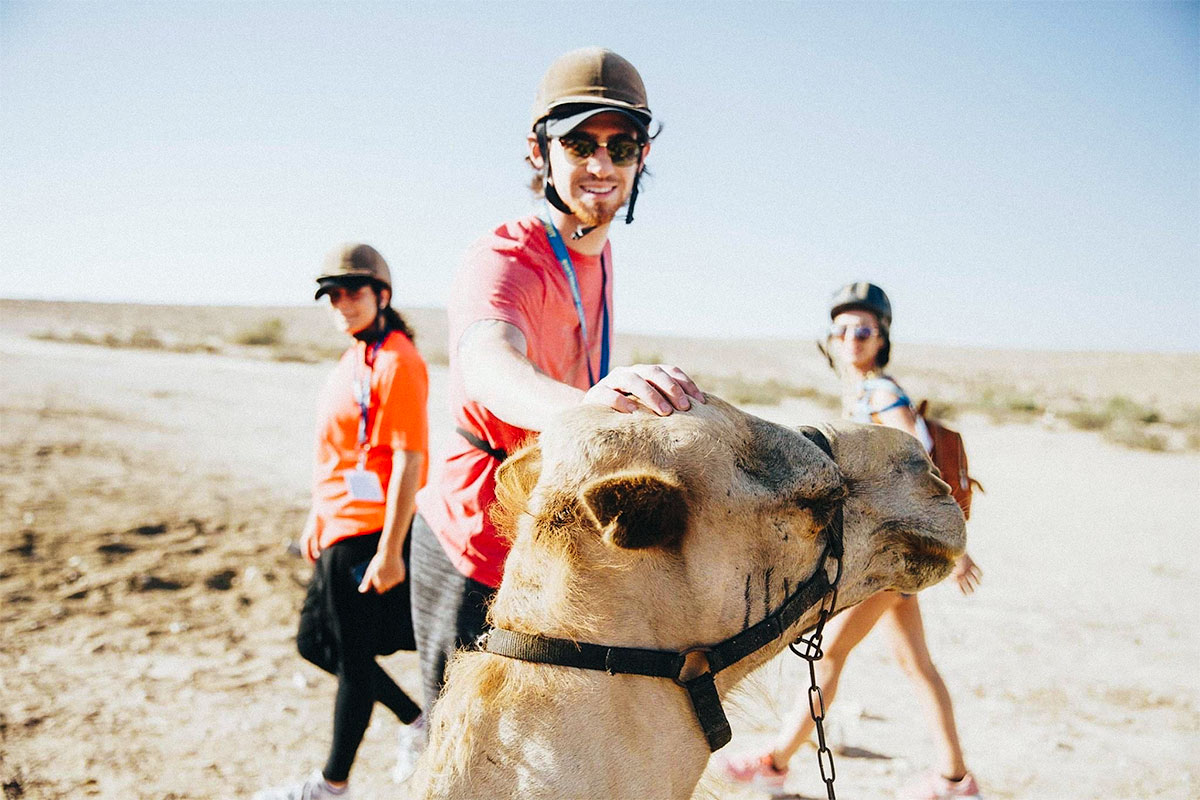 Matt riding a camel in the Negev